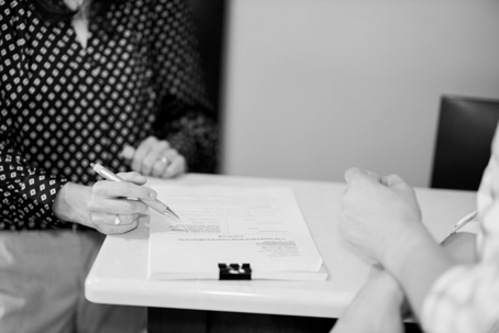 people signing paperwork